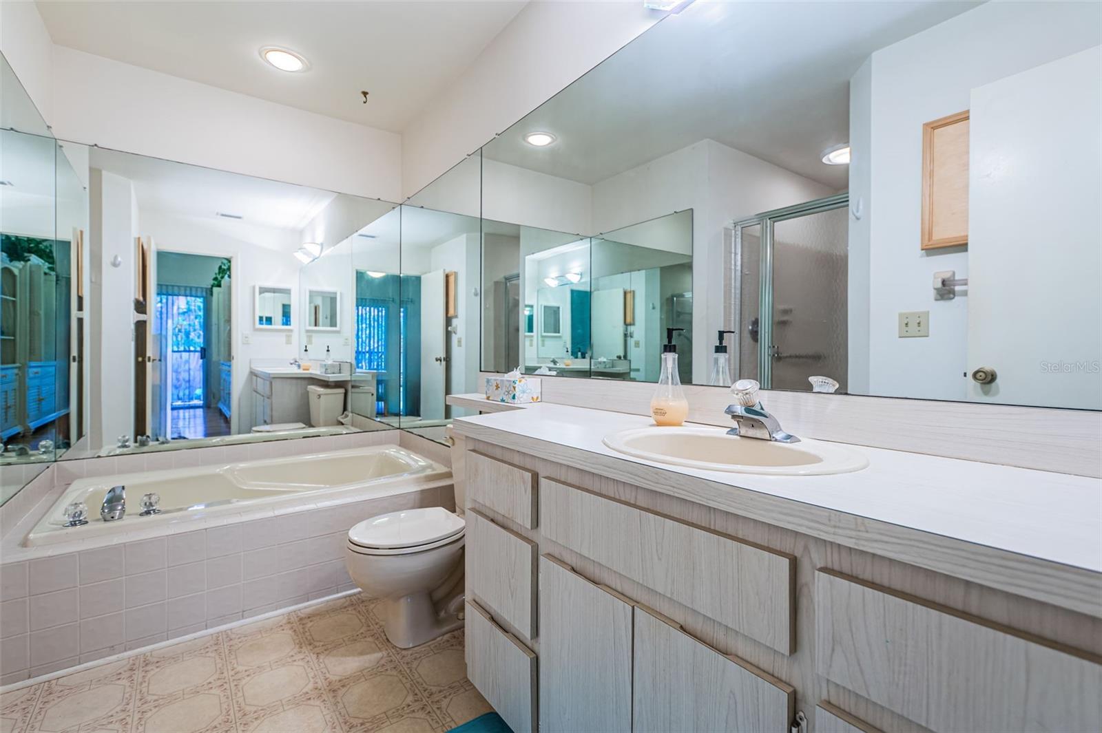 Master bathroom has both a tub and walk-in shower