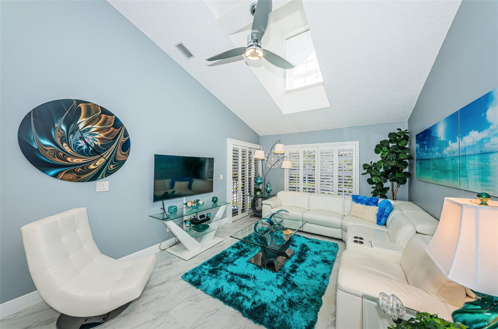 Relaxing, coastal decor with Plantation Shutters and luxury vinyl plank flooring