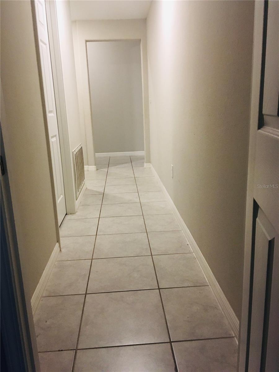 Walkway from Bedroom #4 towards the laundry room on the left and walkway towards front door on the left and kitchen, family room on the right. Very private and open feel.