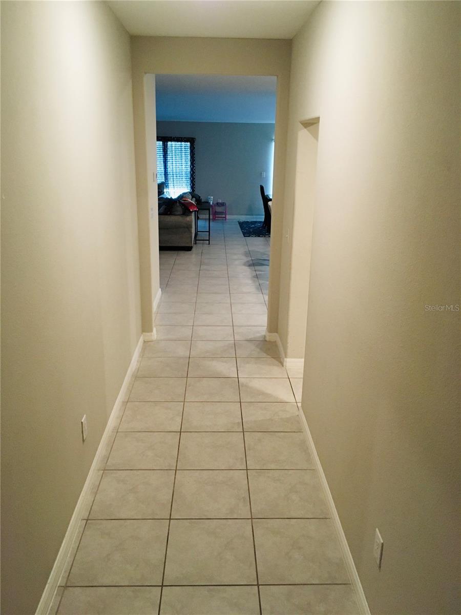 Walkway from Foyer area towards the Family room, Flex Room, Kitchen area.