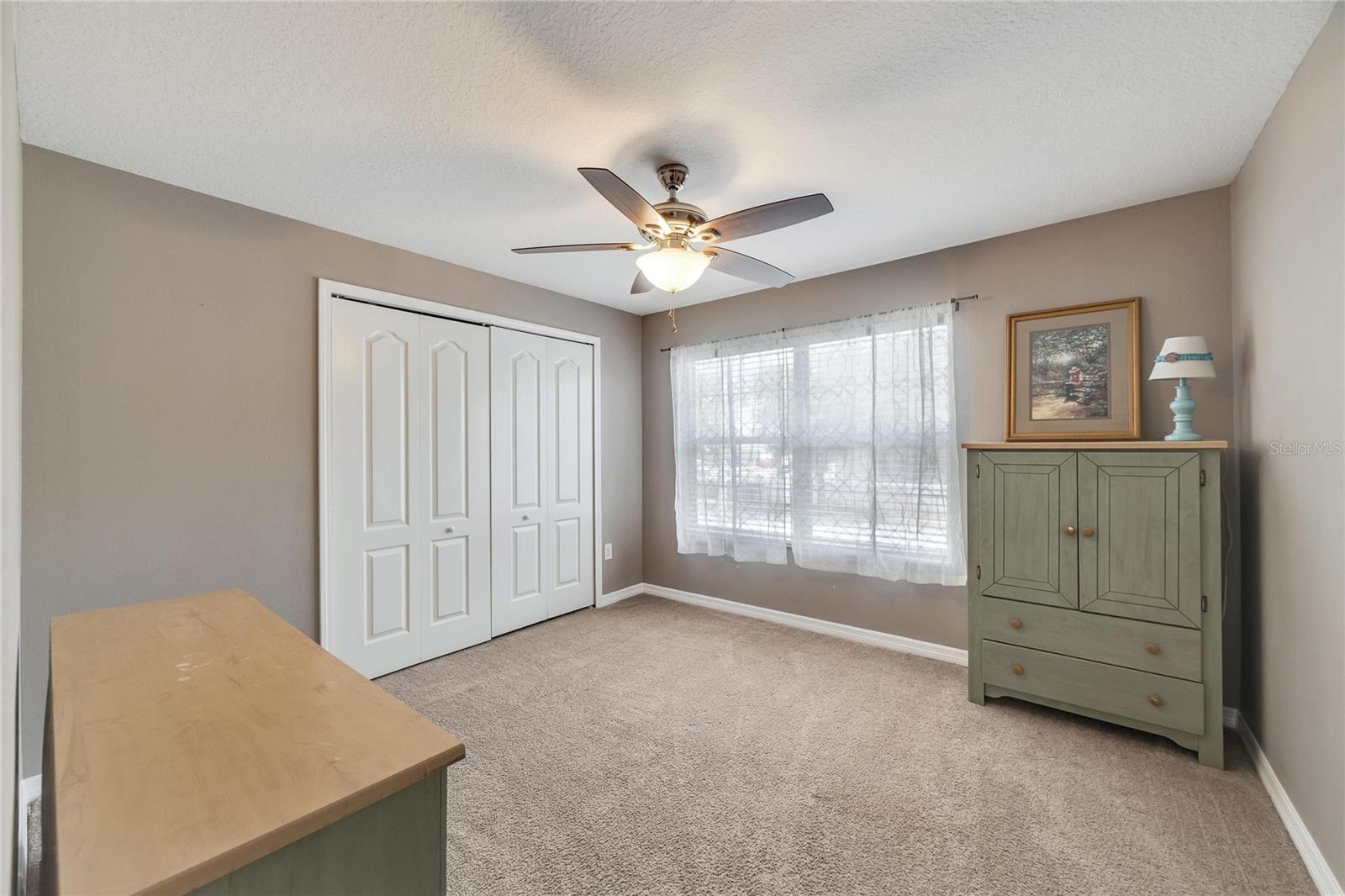 Double windows offer a nice naturally light-filled secondary bedroom located at front of the property.