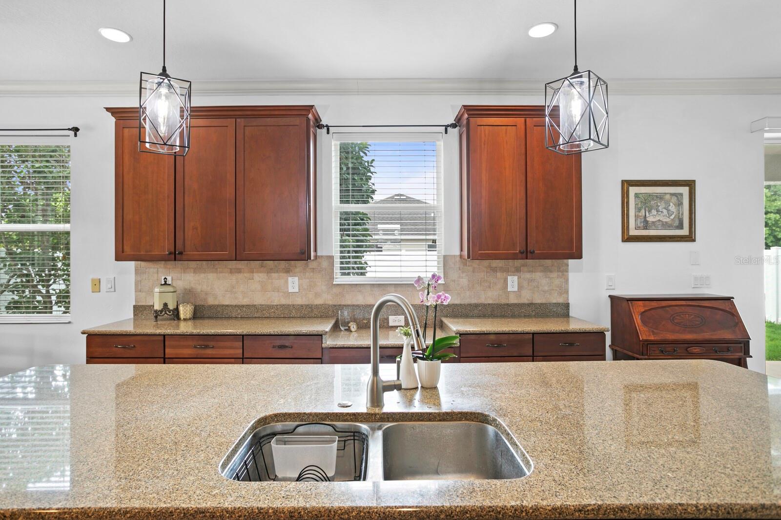 Double basin stainless sink in the large kitchen island