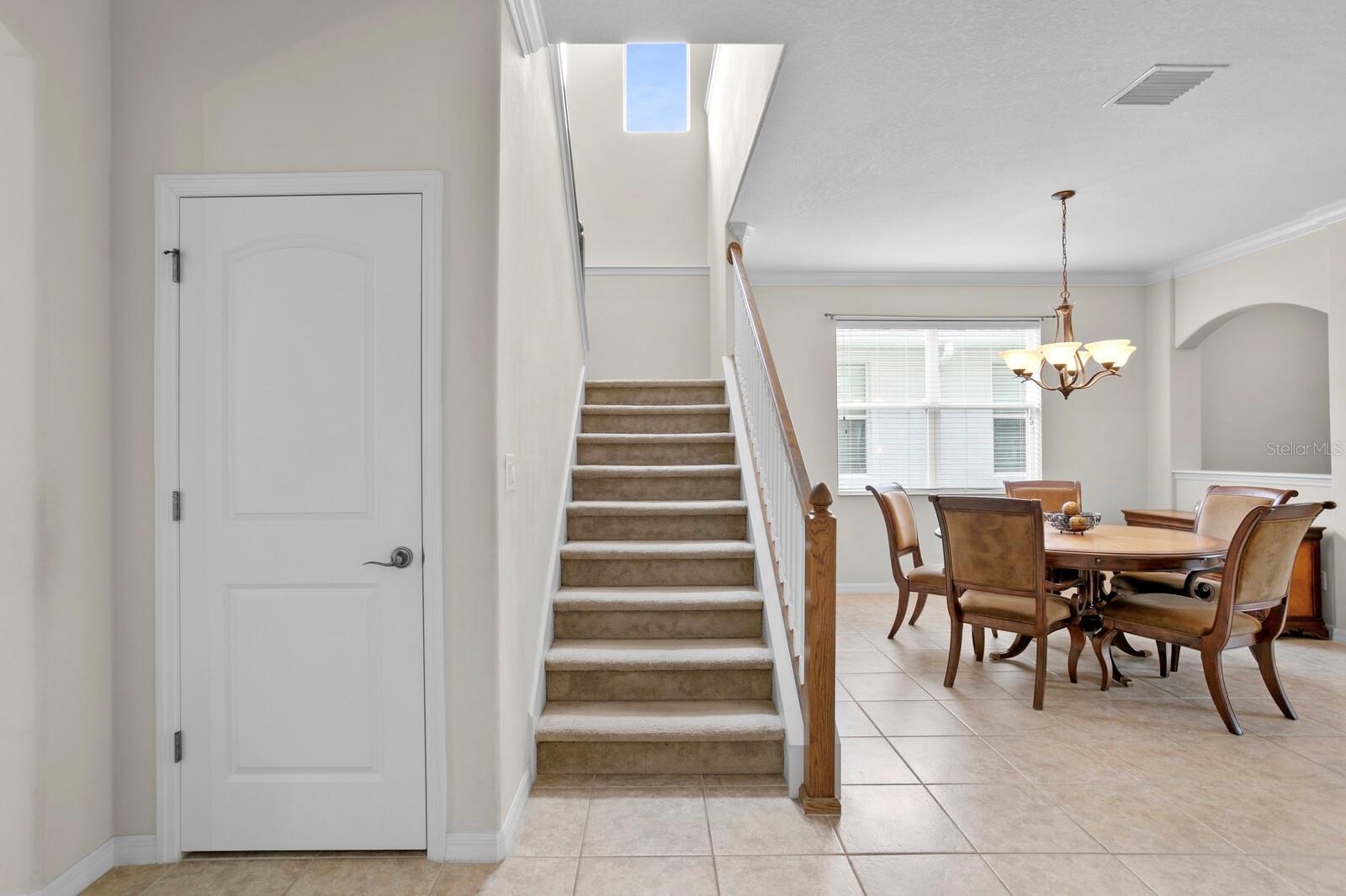 Understairs storage closet and split staircase leads to the 2nd floor