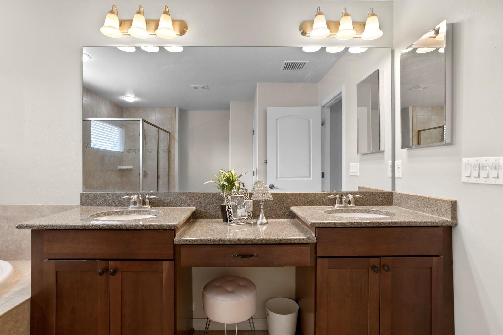 Upgraded granite counters, dual sinks and make-up station in primary bath