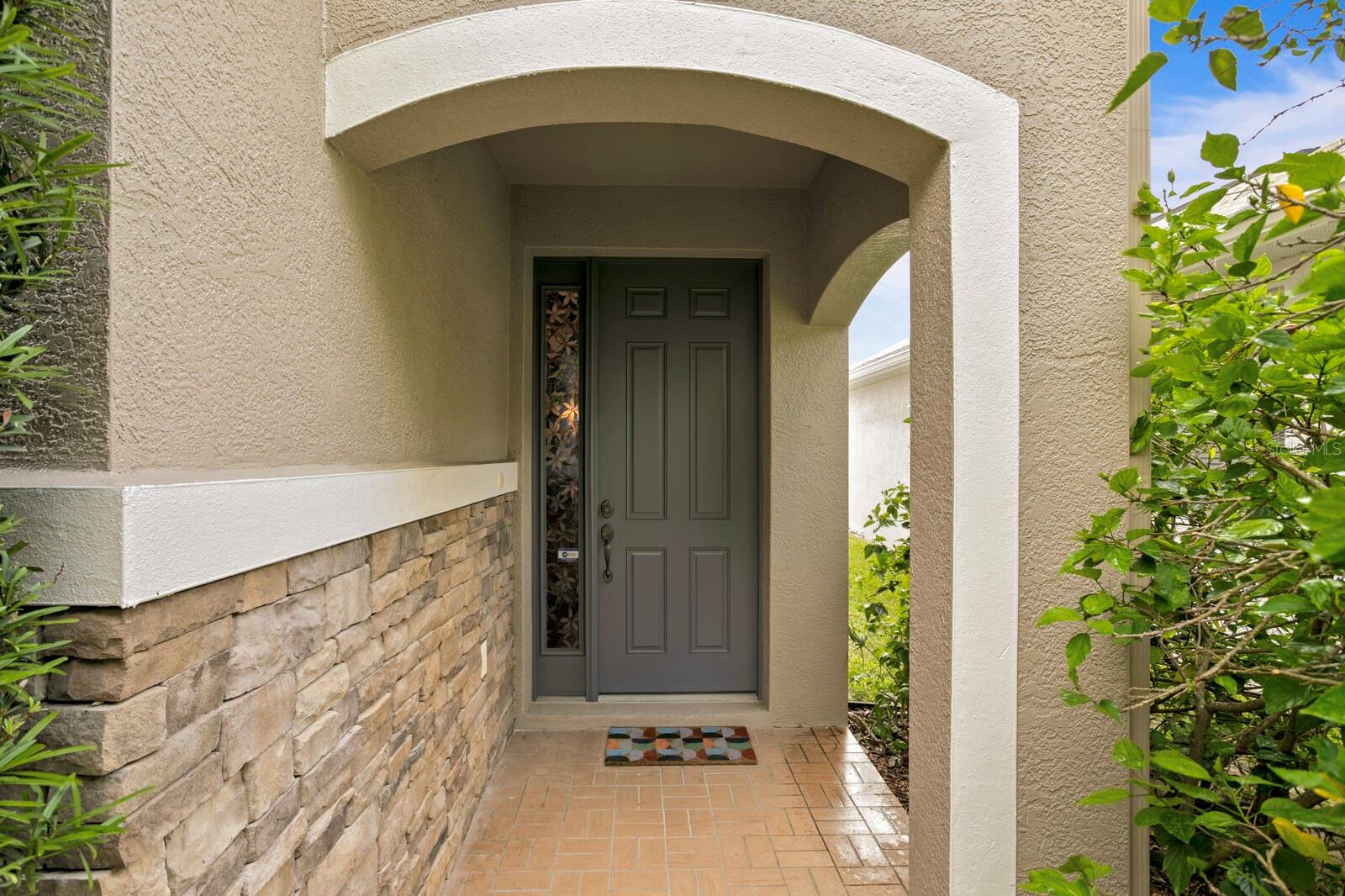 Stacked stone exterior accents and fresh exterior paint make for a welcoming entry