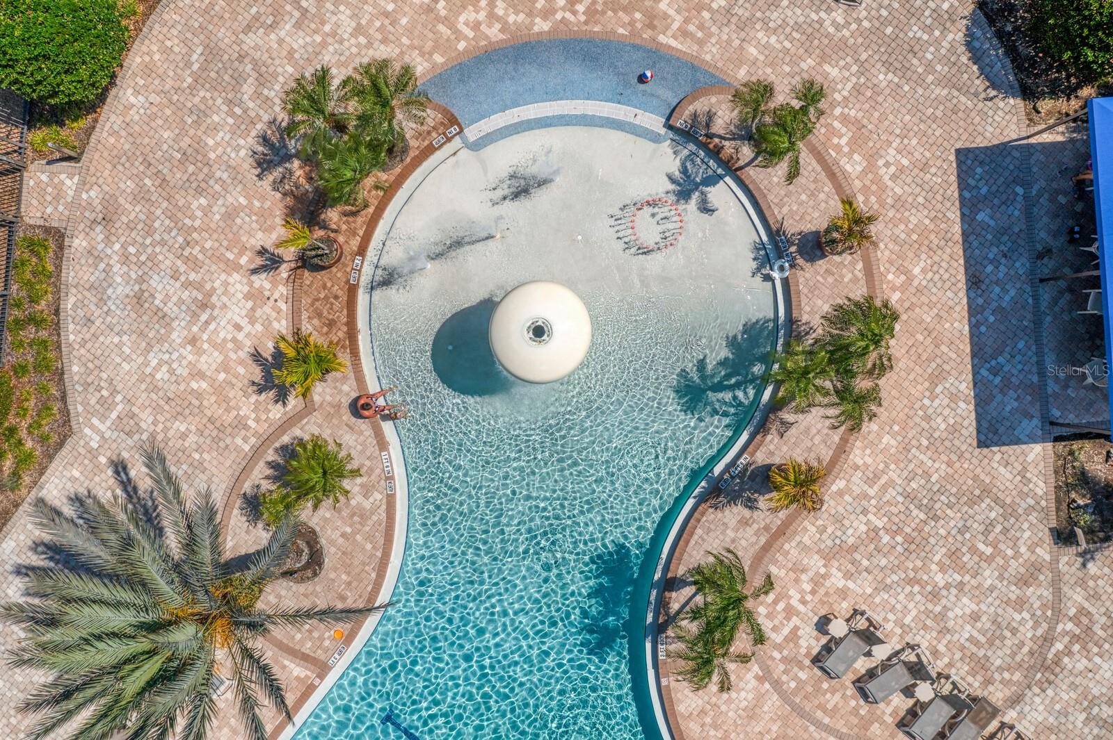 Zero-depth beach entry and splash area at the community pool