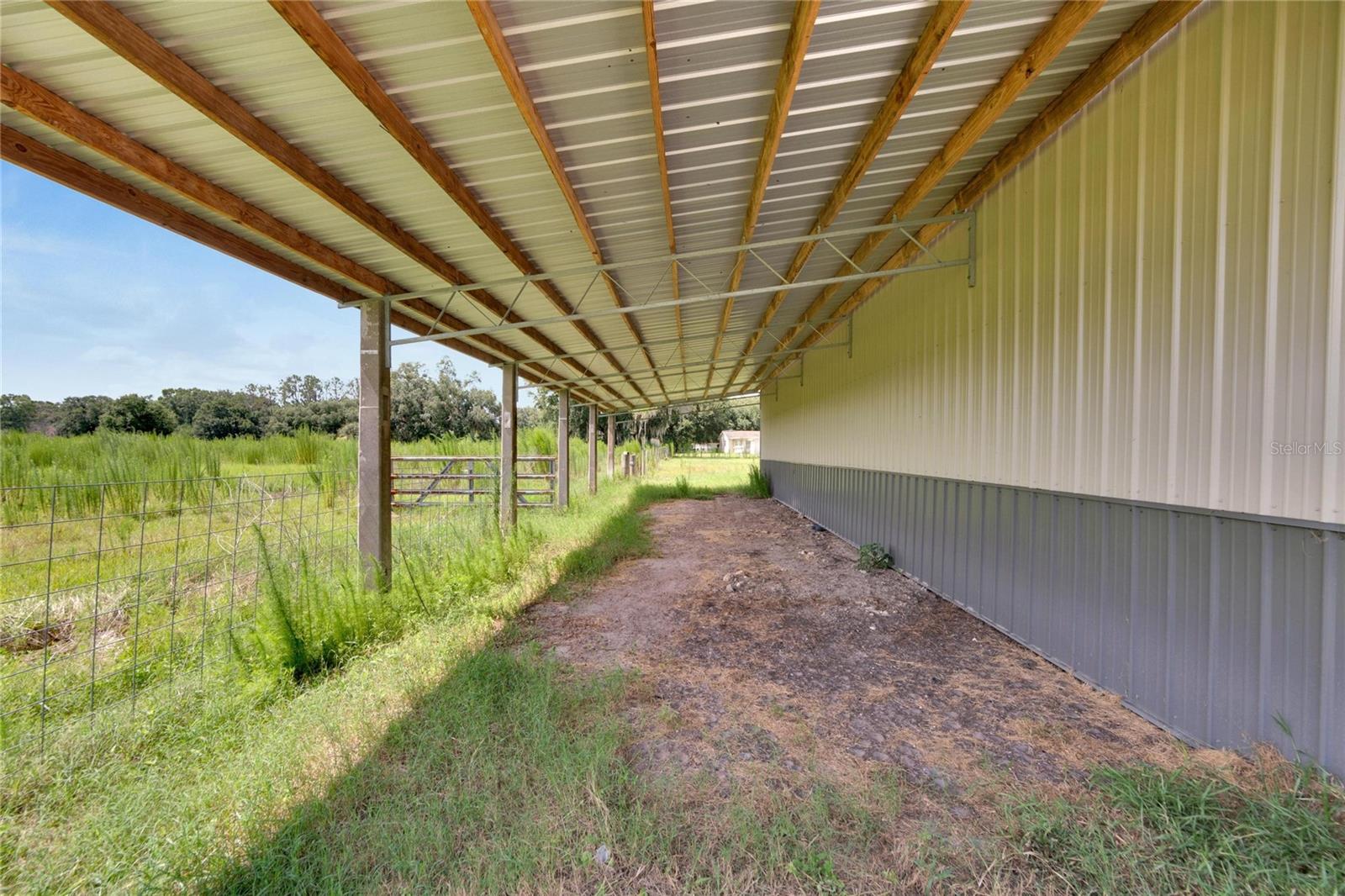 16.7 W X 48 L covered overhang w/gate to pasture