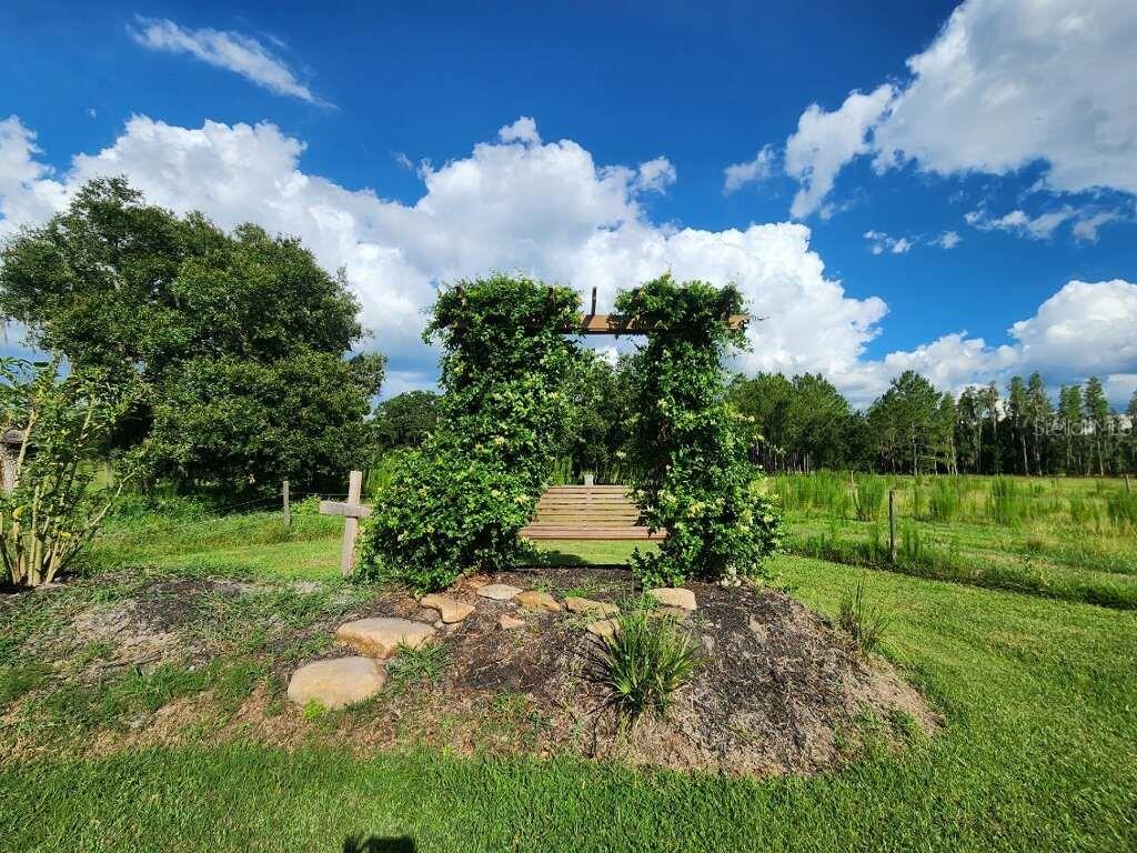 Arbor with swing overlooking the pond