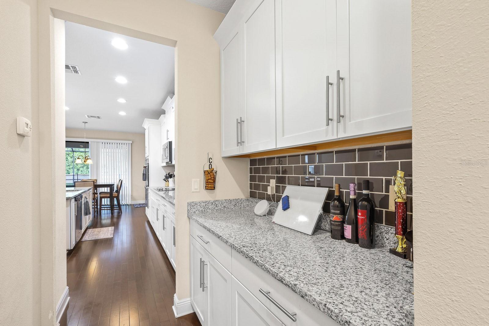 Butler's pantry connecting dining room and kitchen