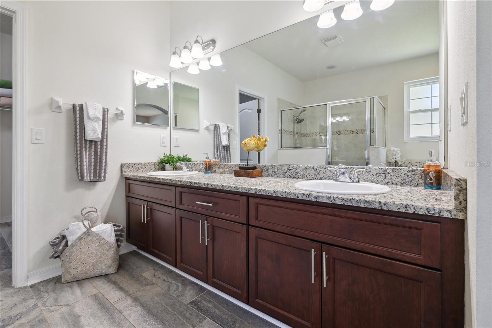 Double vanity has granite countertops