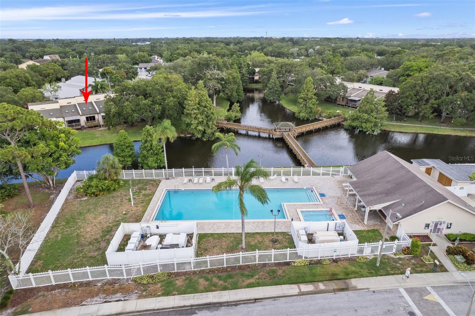 Pool, spa and boardwalk with pavilion over the lake