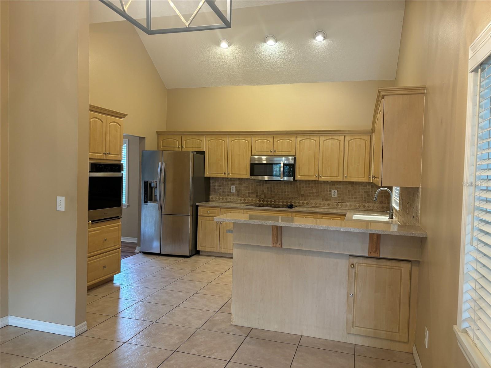 Dinning area looking into kitchen with a breakfast bar