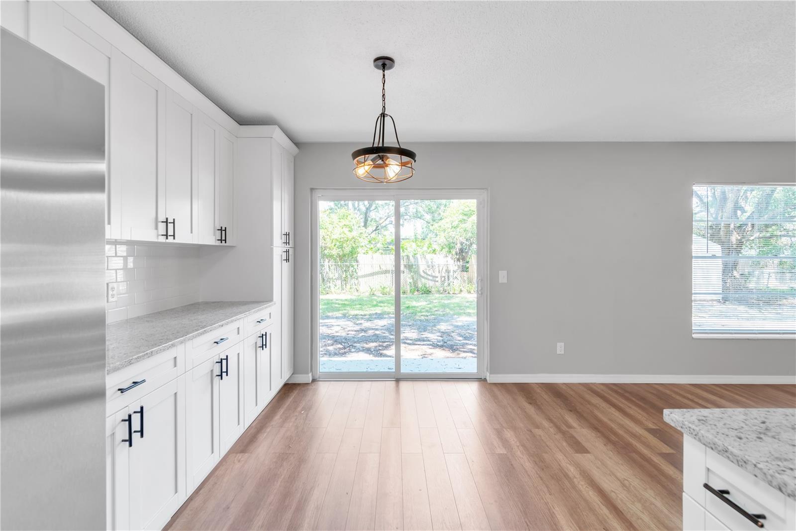 Kitchen and dining room with sliding glass door to back yard