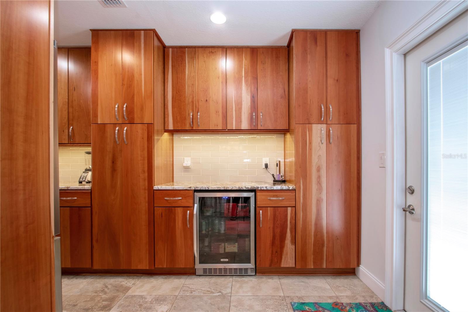 Beverage refrigerator/ exterior door to the fenced portion of the yard