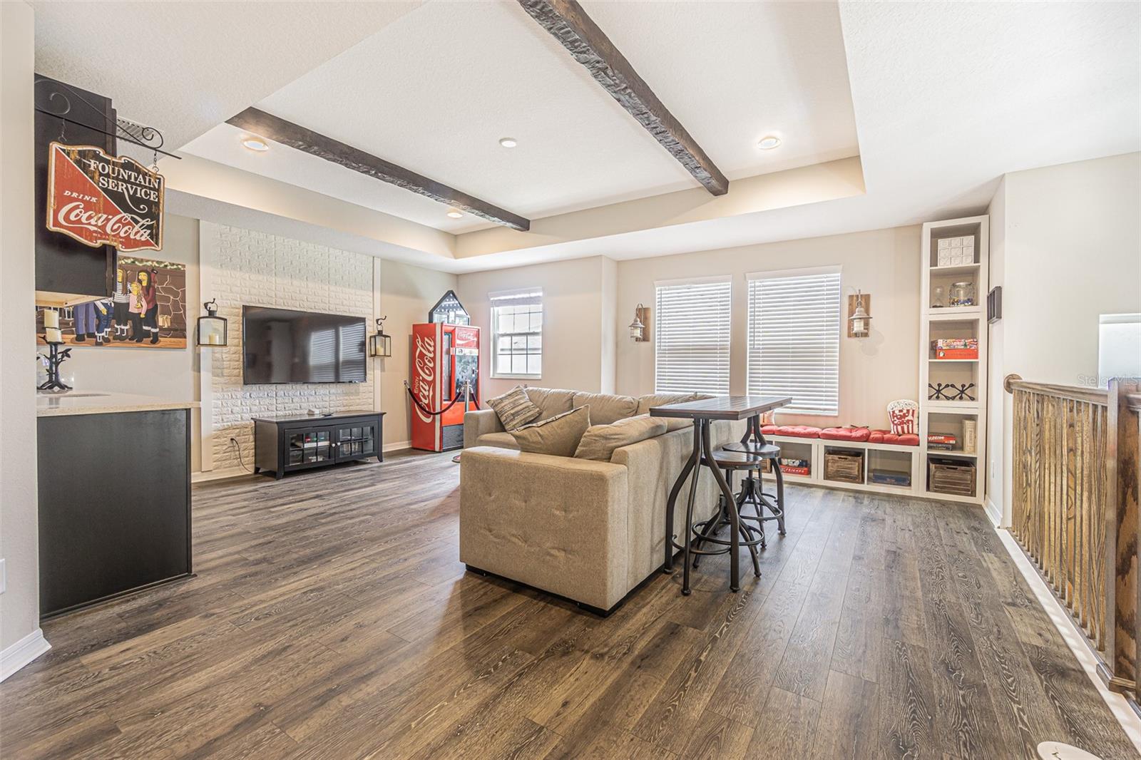 Amazing loft with custom accent wall and lighting, exposed beams, wet bar and cube storage/seating.