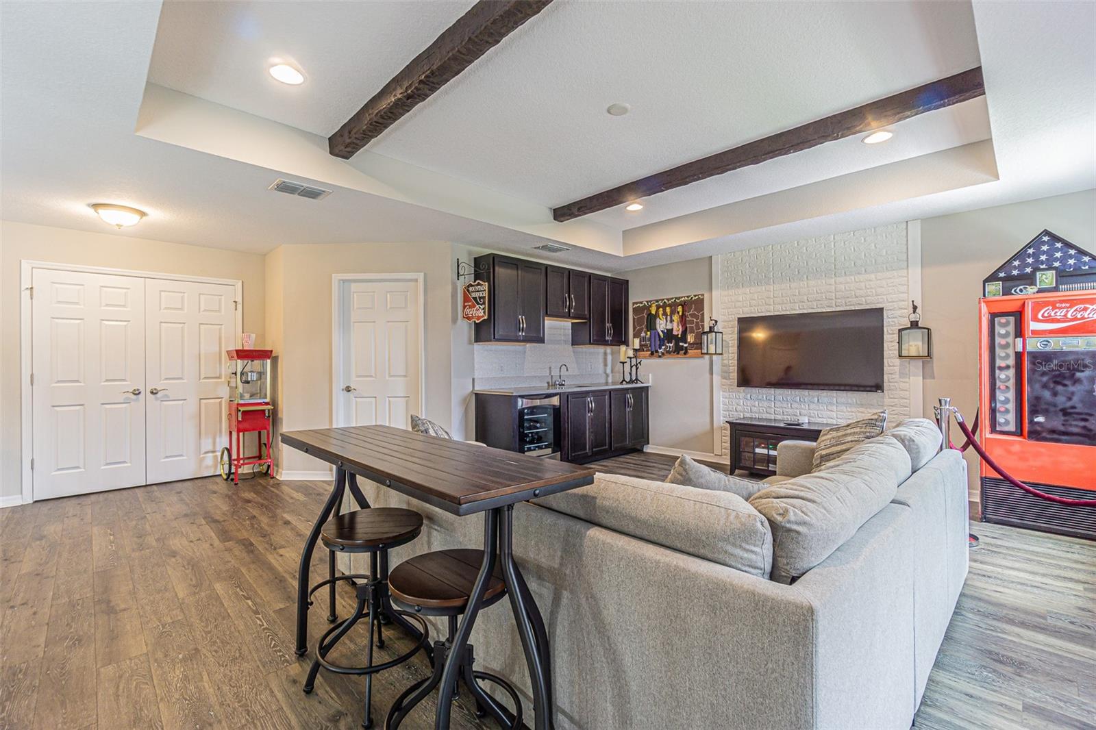 Wet bar with granite countertops and wine/beverage fridge