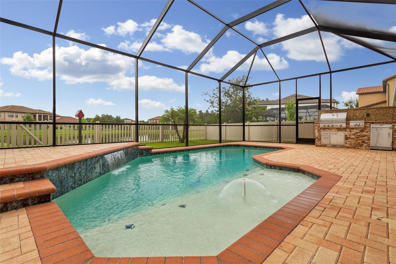 Pool with outdoor kitchen on far side