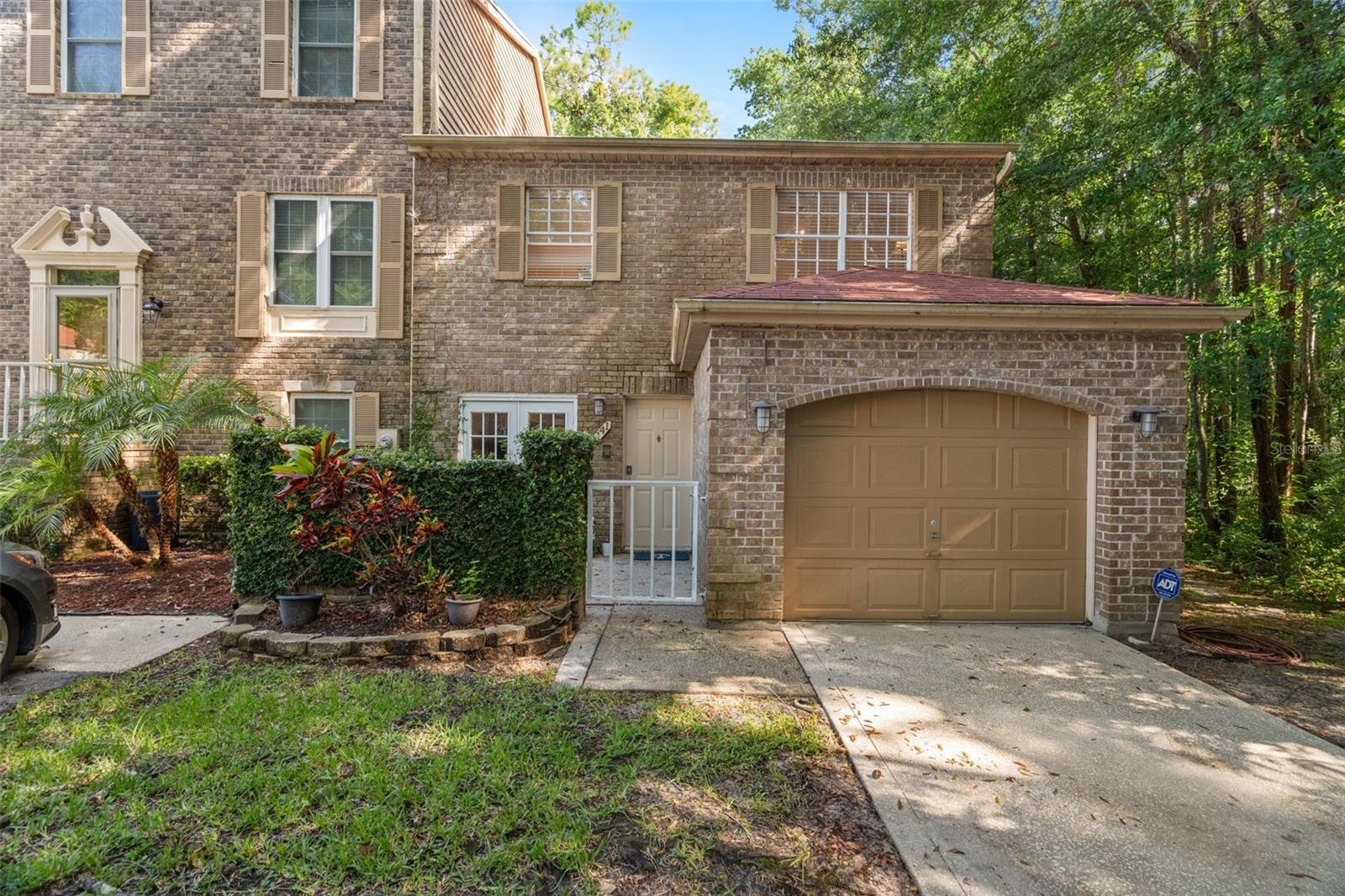 Beautiful stone Front, End Unit, with gated front patio and 1 car garage