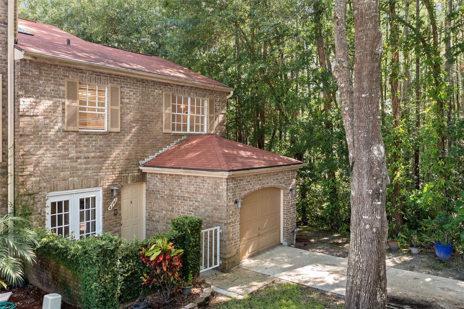 Beautiful stone Front, End Unit, with gated front patio and 1 car garage