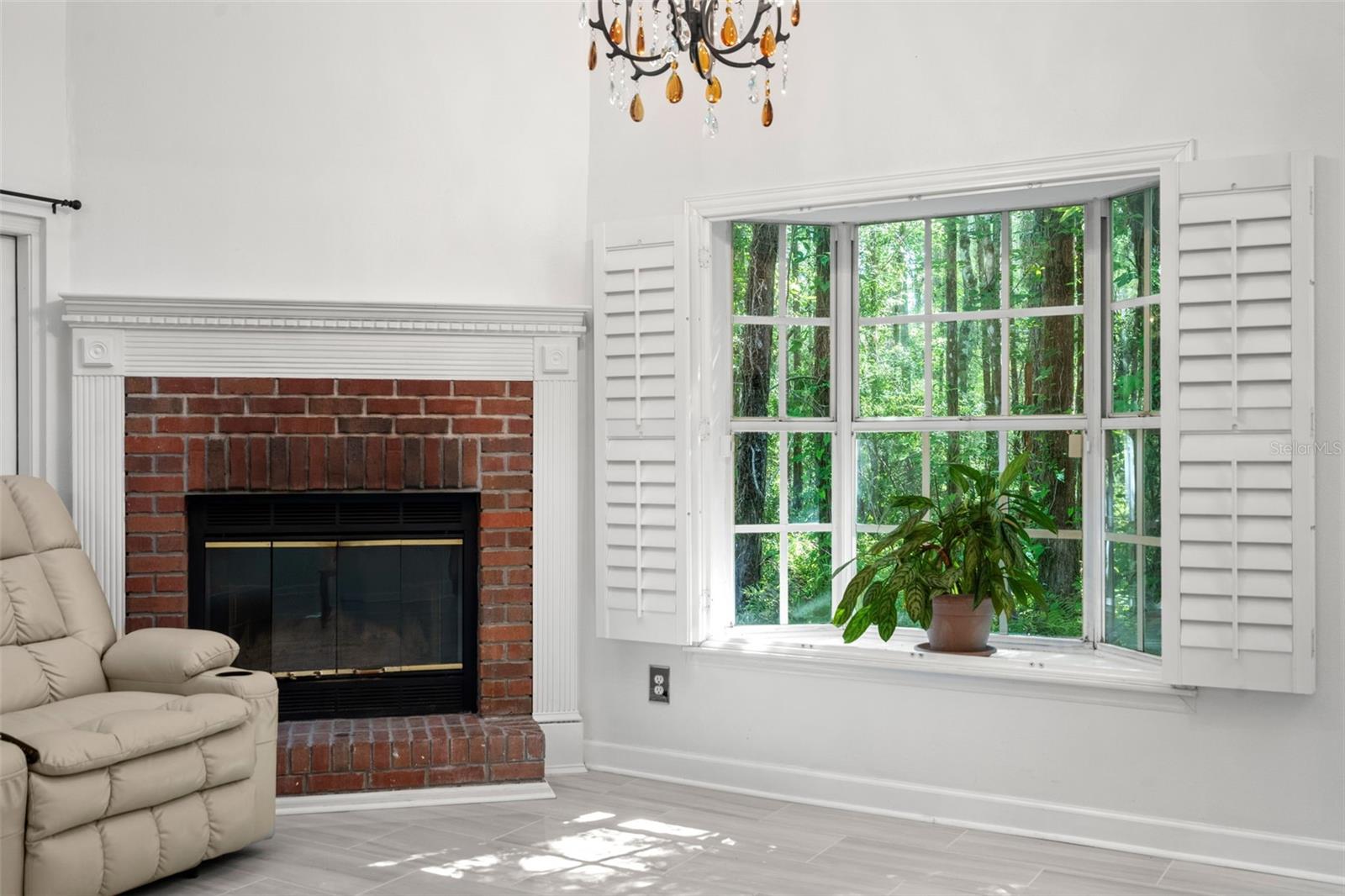 Wood Burning Fireplace, New Tile in Large Living Room with Cathedral Ceilings and lots of light