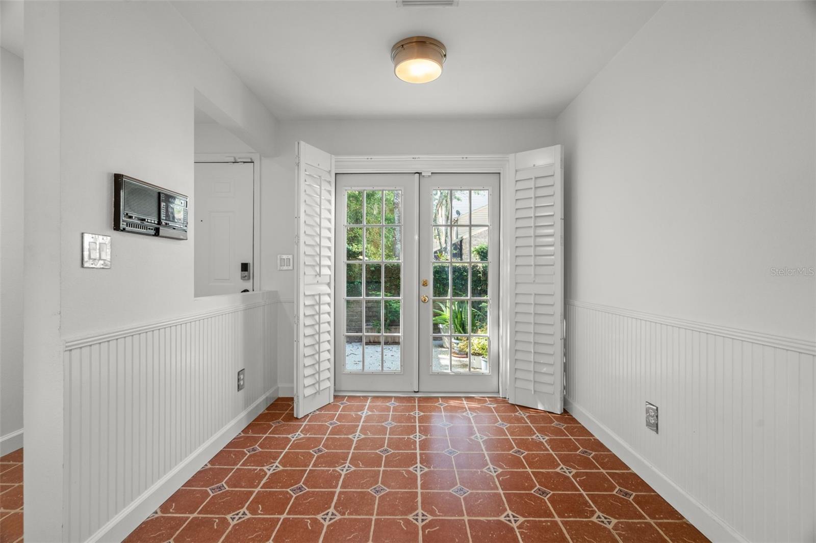 Breakfast nook with french doors leading out to front patio