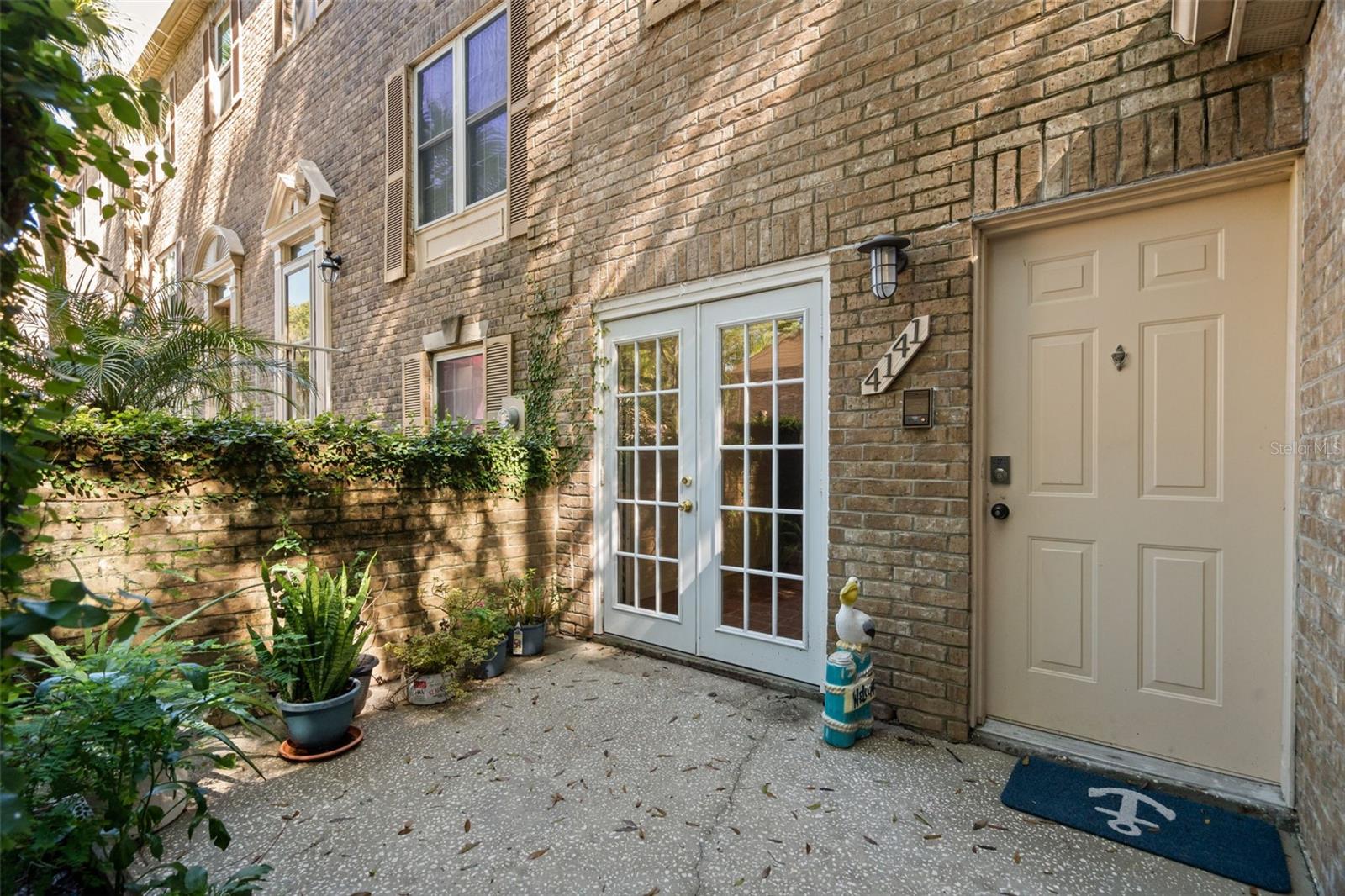 Beautiful stone Front, End Unit, with gated front patio and 1 car garage