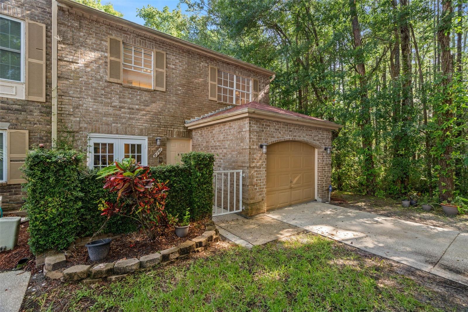 Beautiful stone Front, End Unit, with gated front patio and 1 car garage