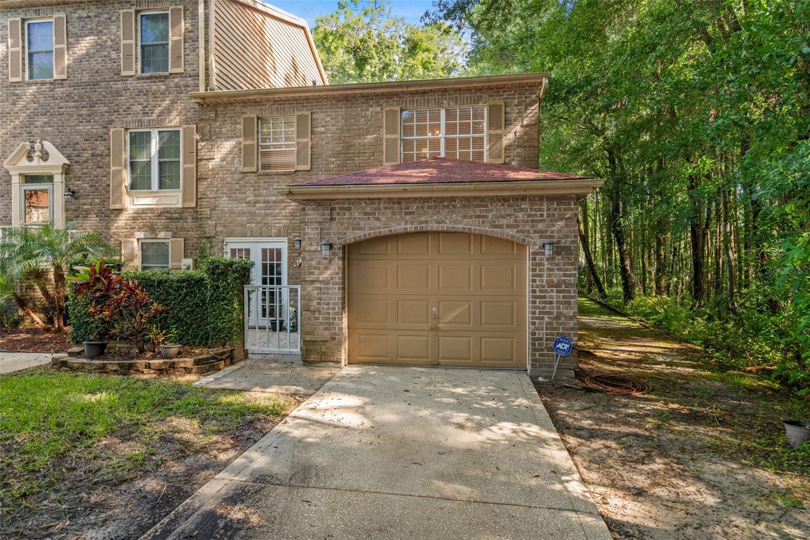 Beautiful stone Front, End Unit, with gated front patio and 1 car garage