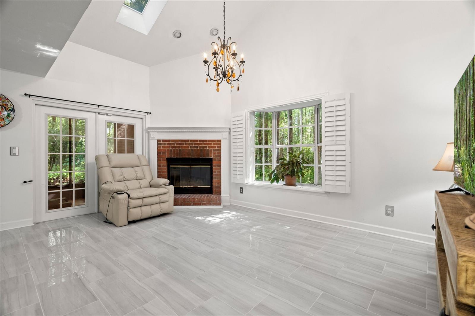 Wood Burning Fireplace, New Tile in Large Living Room with Cathedral Ceilings and lots of light