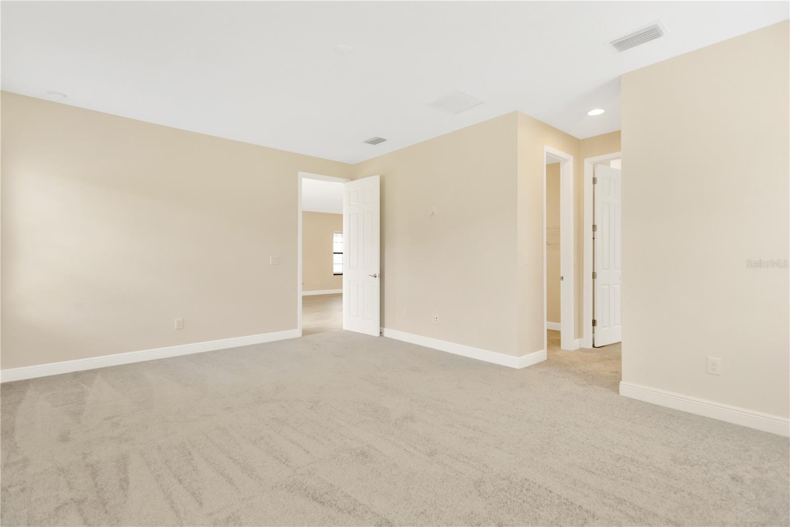 The 18' x 14' owner’s retreat is carpeted and has 2 oversized walk-in closets and a gorgeous en-suite spa-like bathroom.