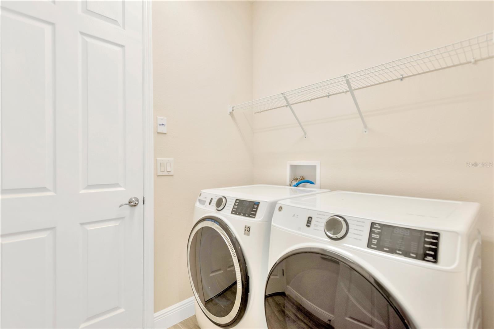 Washer & Dryer convey to the Buyer.  Door leads to garage.