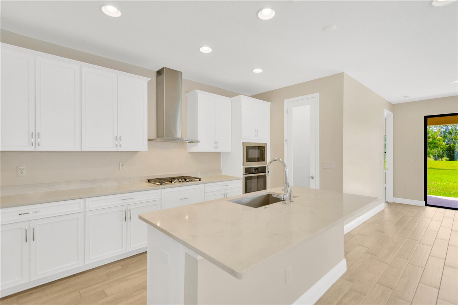 42” white cabinets with nickel pulls, stylish quartz countertops, and impressive appliances.