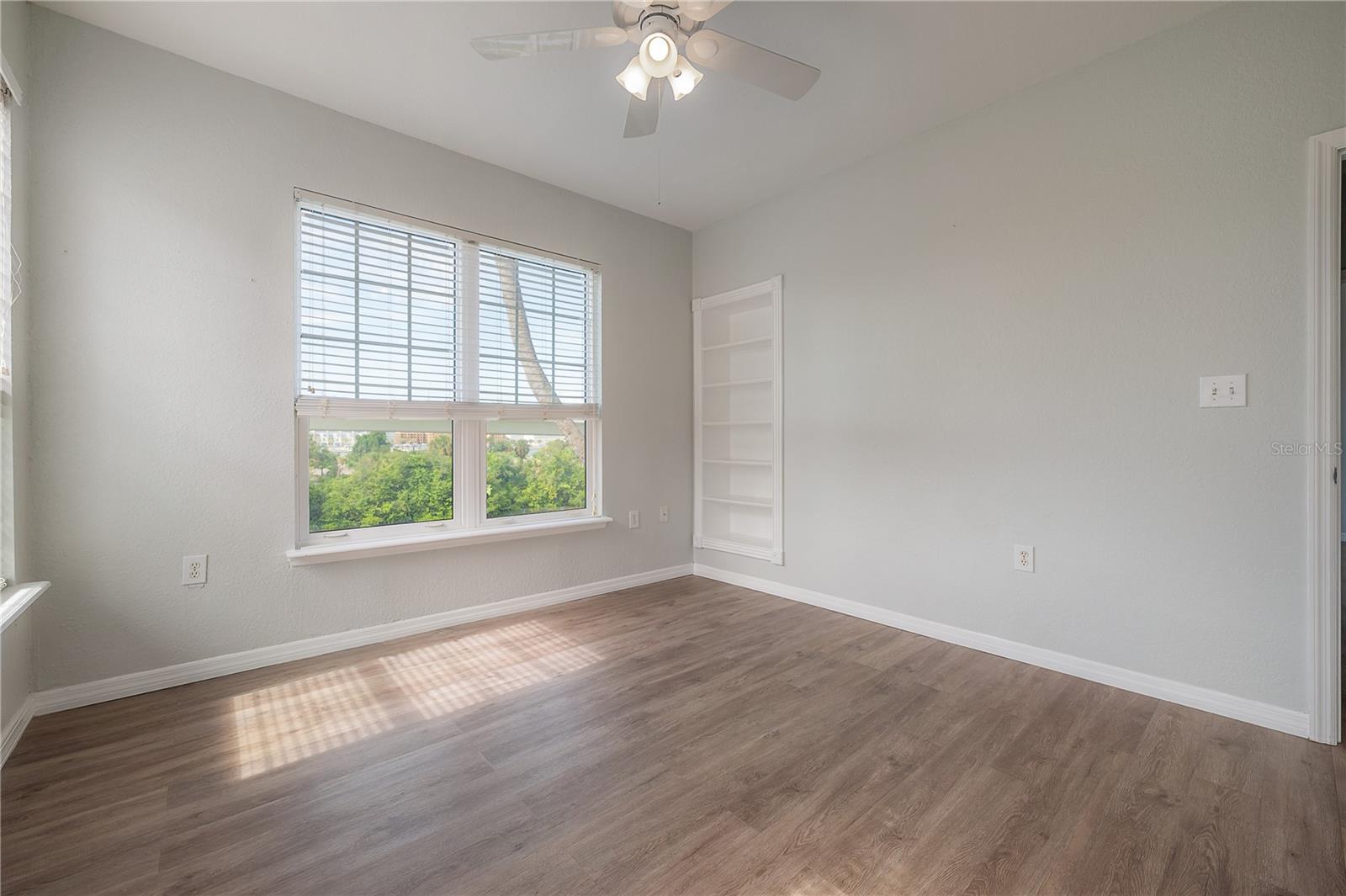 Bedroom 2 with built-in bookshelves. Perfect as an office!