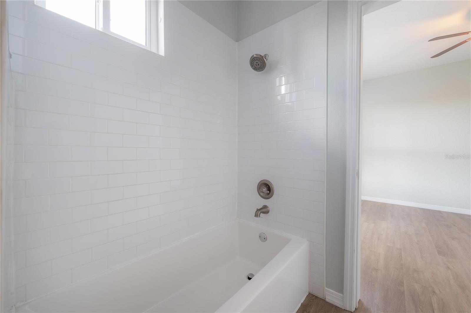 White subway tile surround of bathtub/shower