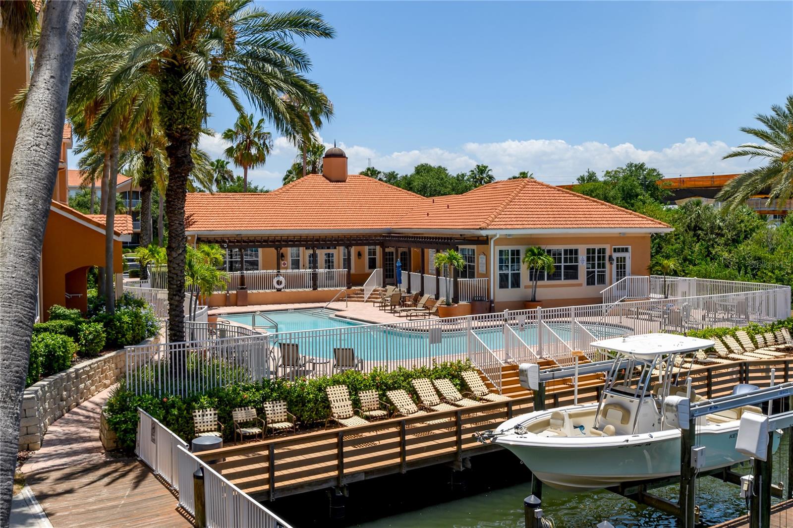 Community clubhouse, pool and fitness center overlooking the private marina.