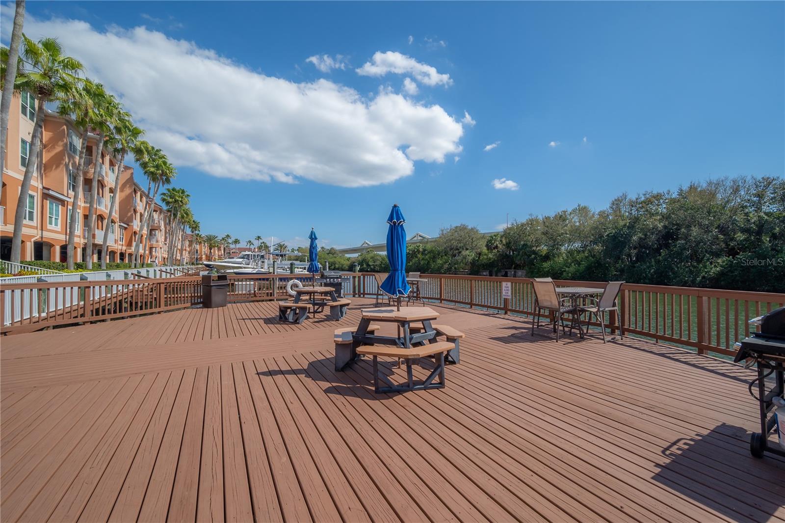 Community area with table and grill along marina boardwalk