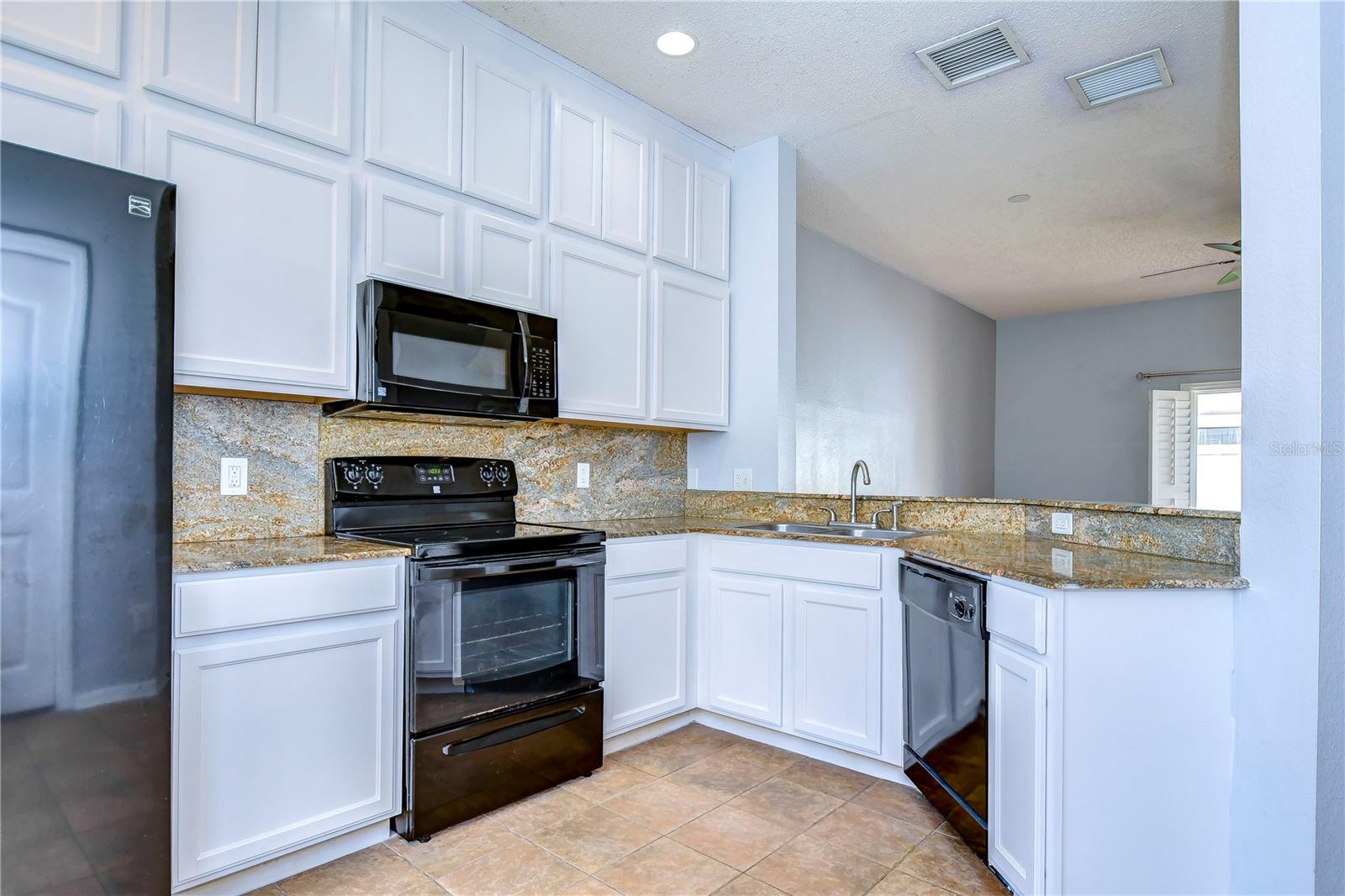 Double-stacked white cabinets, granite countertops!