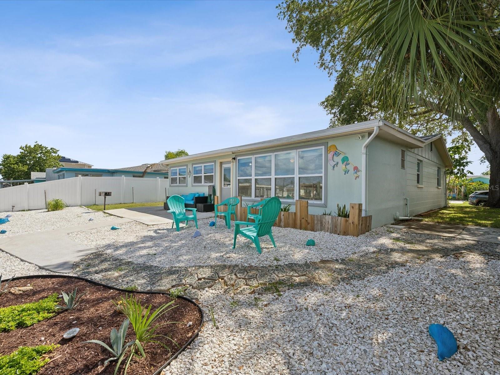 Crushed seashells provide a nautical and low maintenance vibe in the backyard