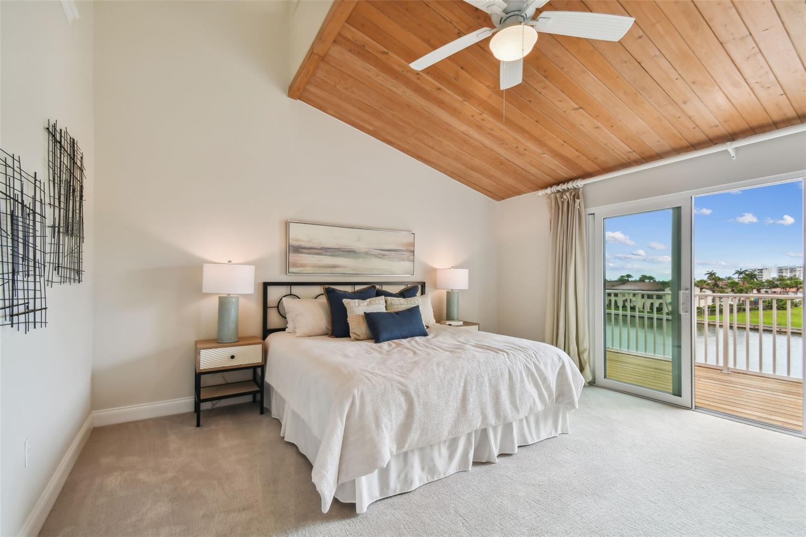 Primary suit with vaulted ceilings, waterfront balcony, remodeled bath and huge walk-in closet