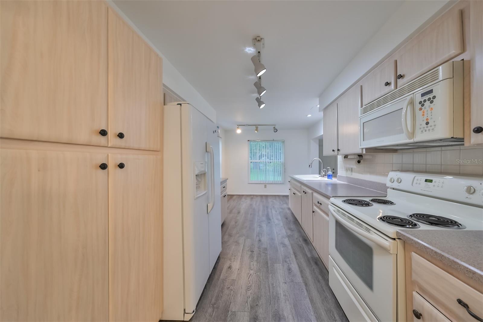 Refreshed Kitchen with Eating Area Looking out to Lake.