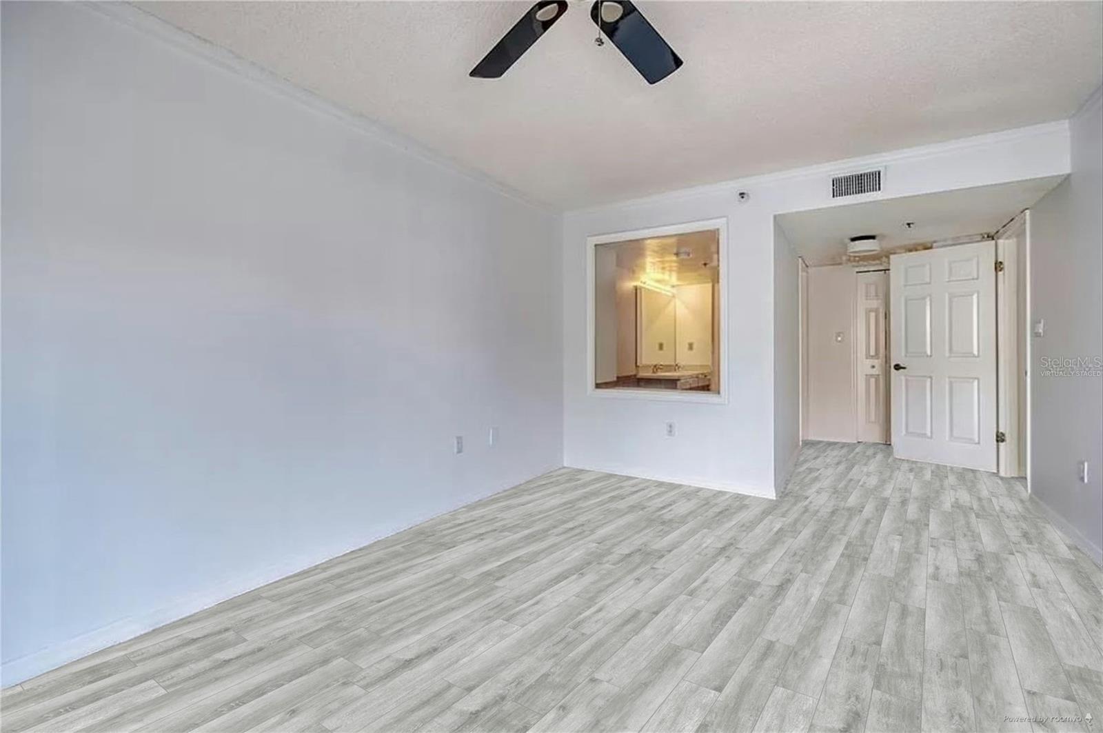 Primary bedroom with virtually staged flooring