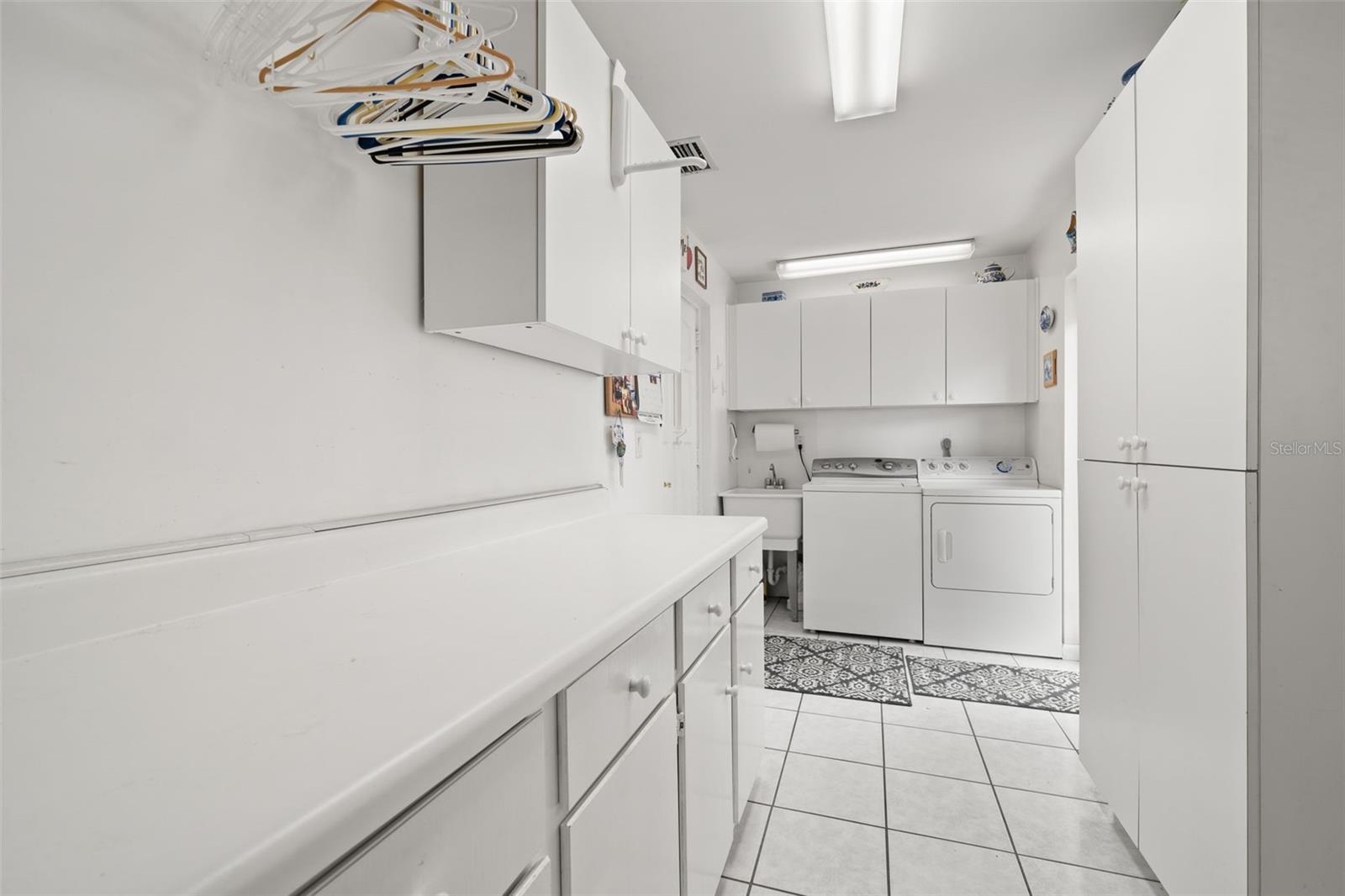 Laundry room with lots of storage leads to the garage