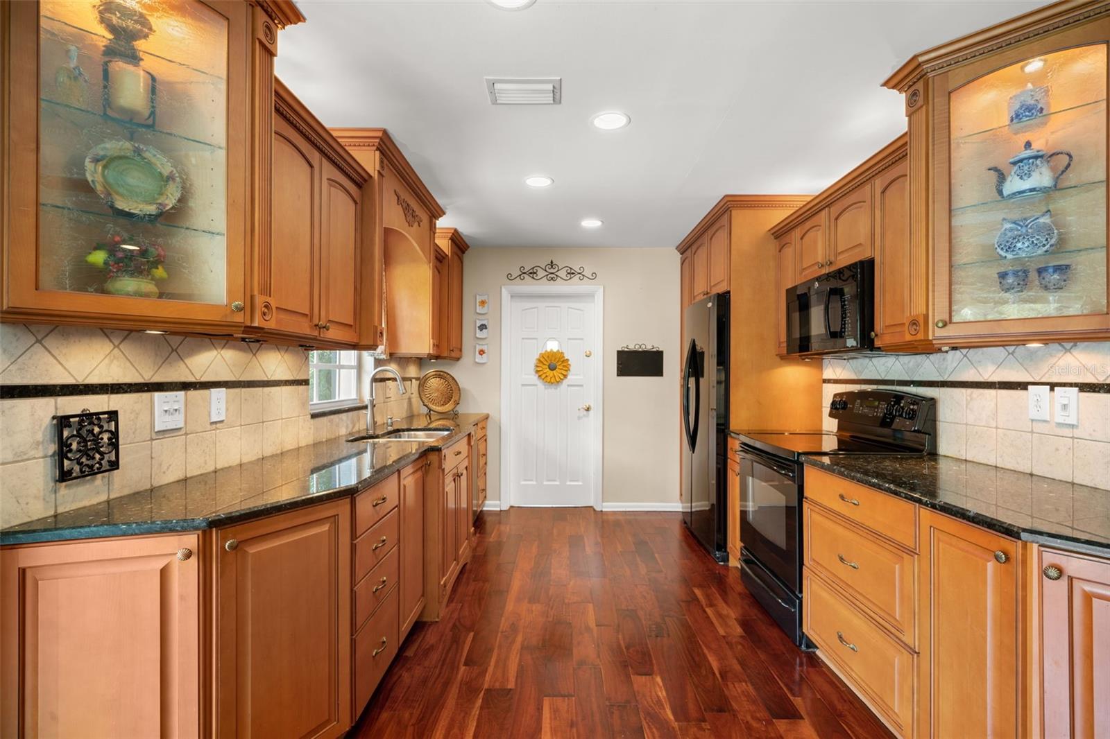 updated kitchen with wood flooring.