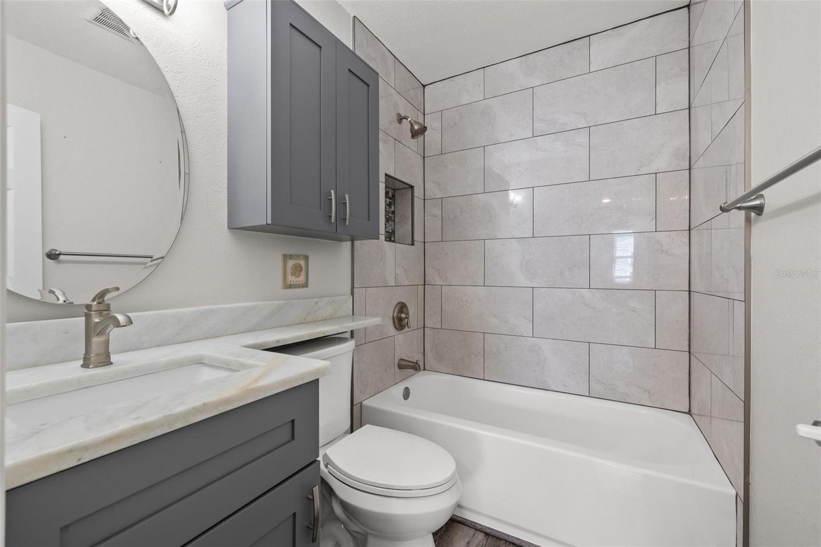 Bathroom with tub shower and granite counter tops