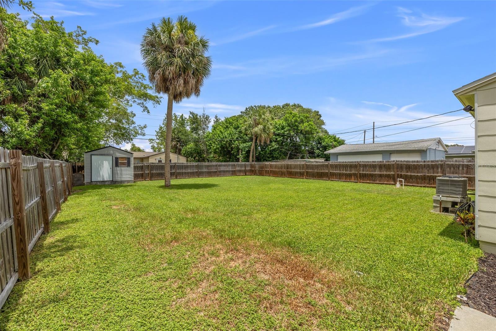 Cleared lot with plenty of space and a shed in the back corner for tools, lawn equipment or strage