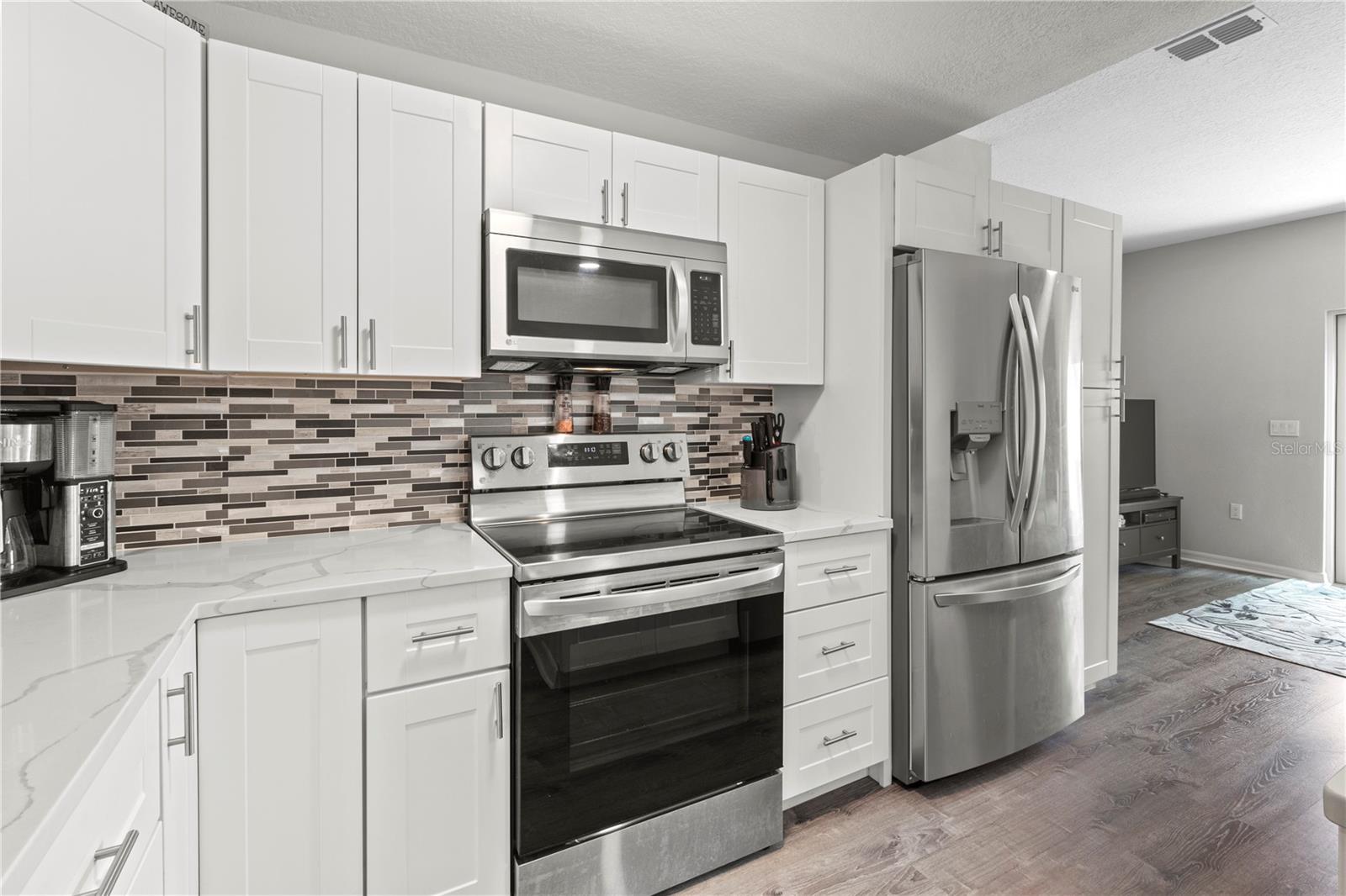 Nice sized pantry next to the refrigerator