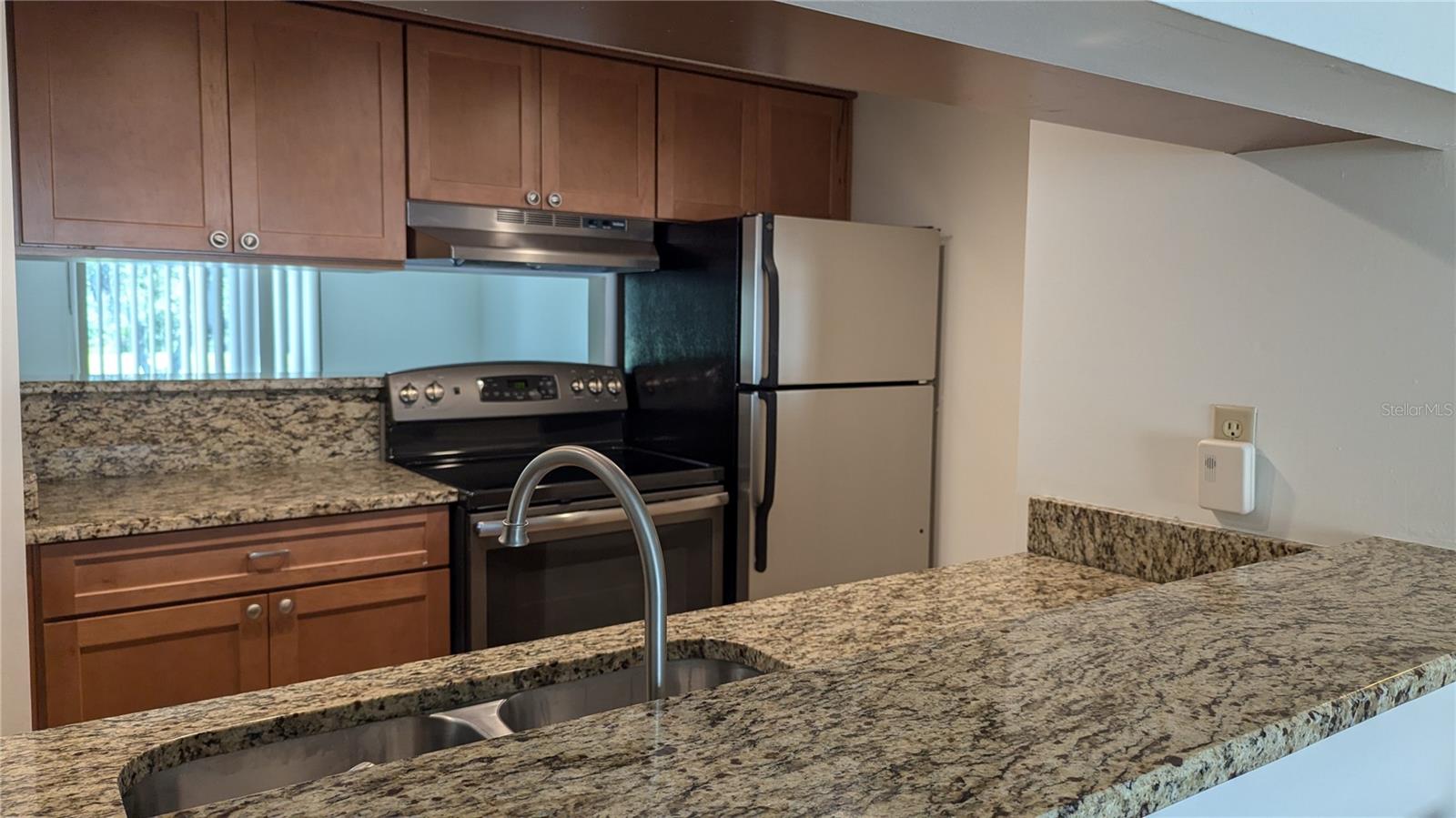 Remodeled Kitchen with granite counters and wood cabinets