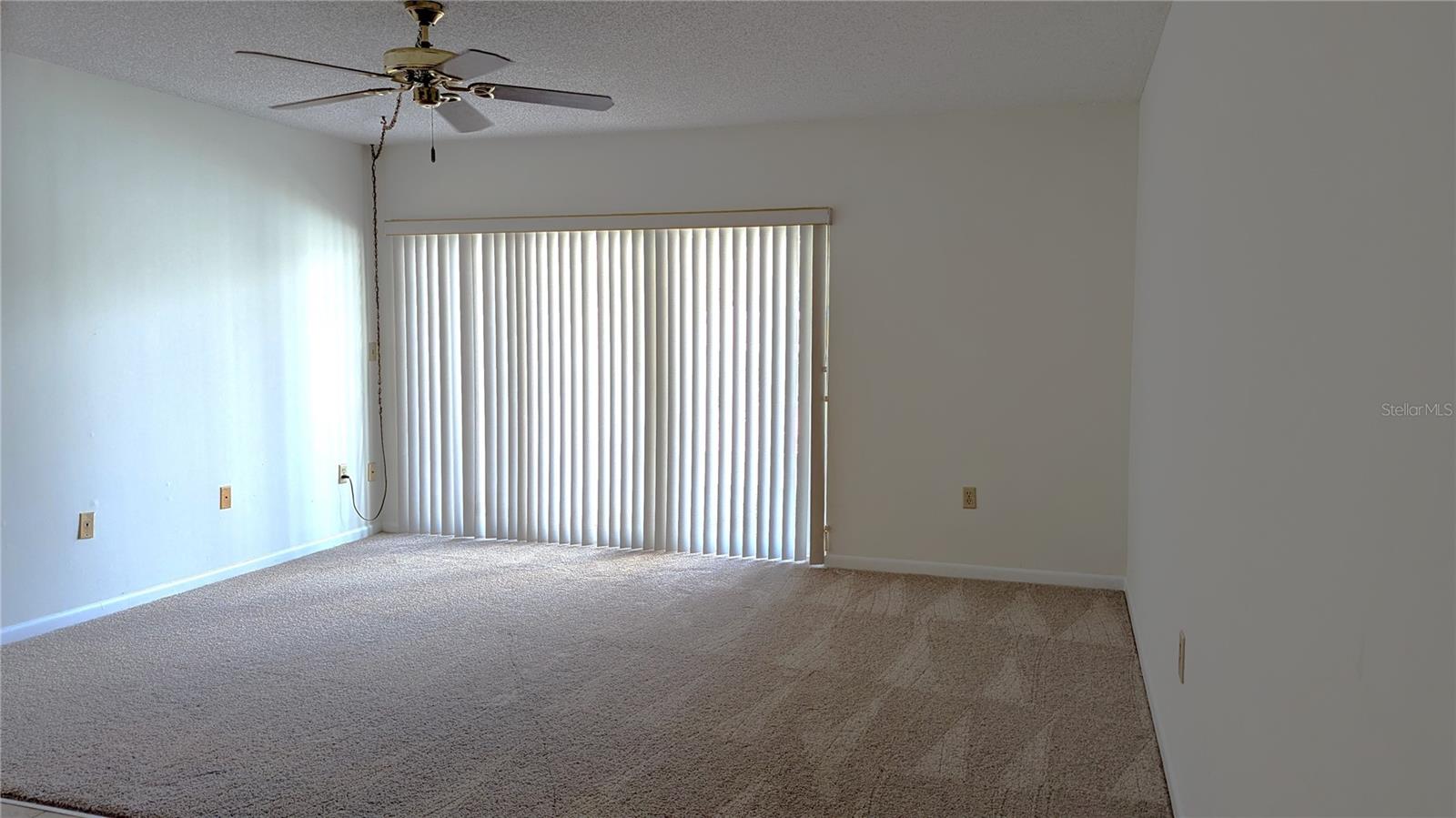 Living Room with sliders to pool, brand new carpet