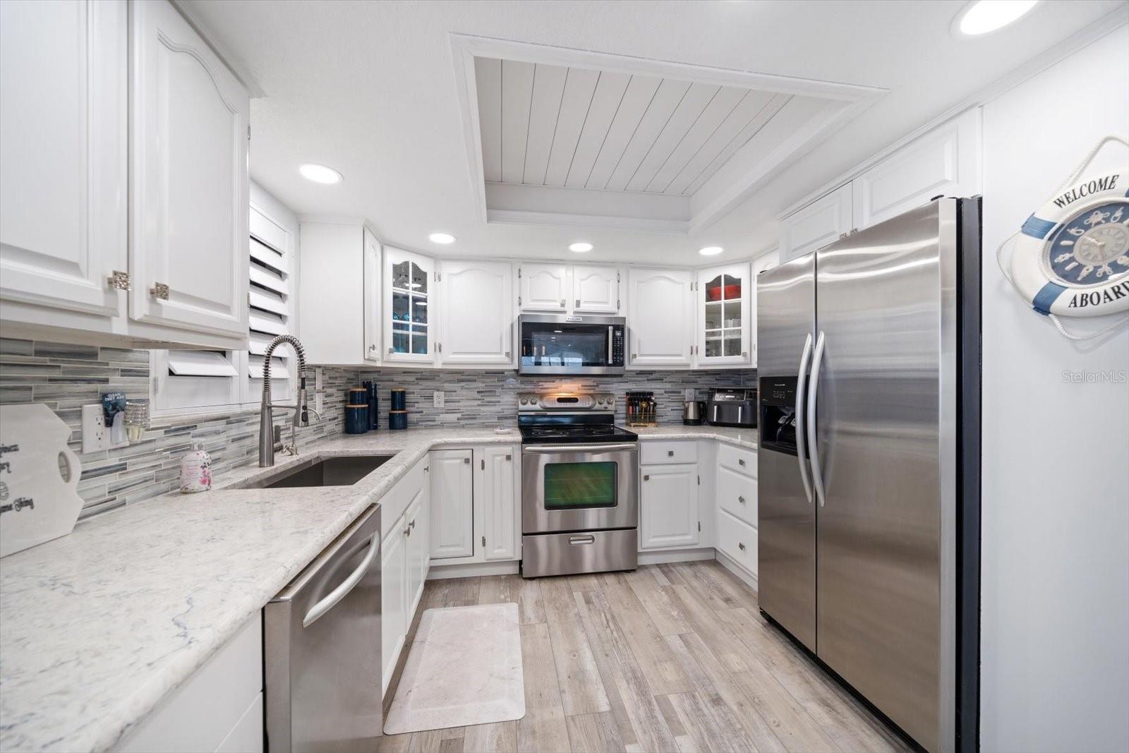 Kitchen is beautiful! Stainless appliances with attractive stone counters include custom cabinetry, lazy Susan, and additional storage.