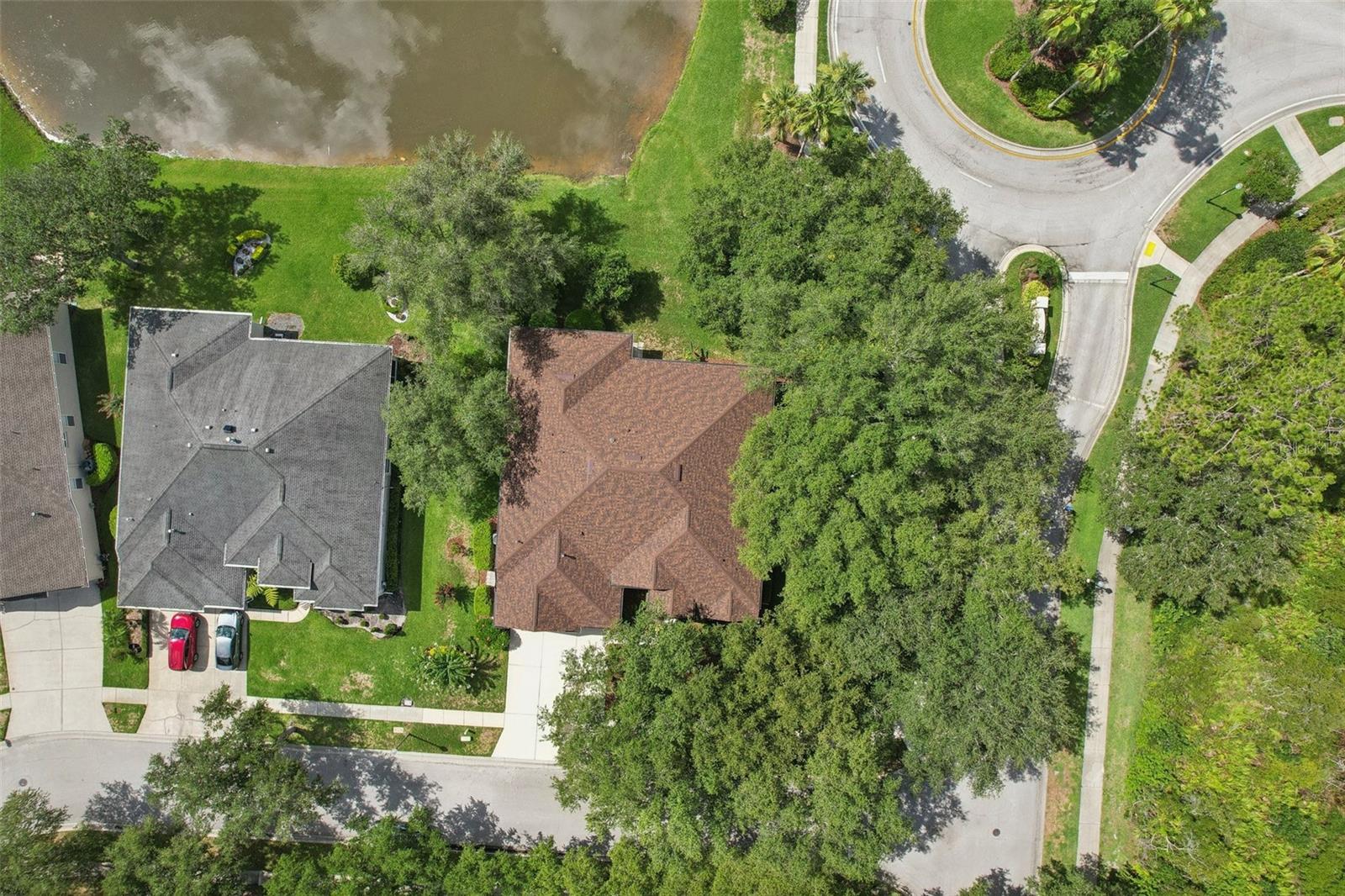 Aerial view of the corner lot, roof and pond